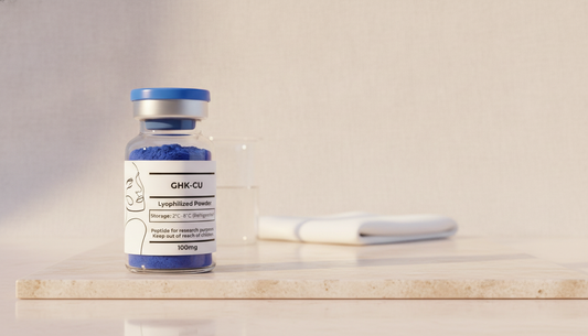 A GHK-Cu vial of deep blue lyophilized powder on a travertine slab beside a glass beaker